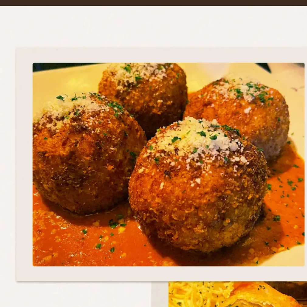 Fried Macaroni and Cheese balls, a Cheesecake Factory happy hour appetizer, served with marinara sauce